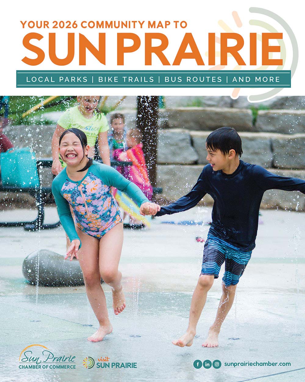 Person's head is submerged in a pile of corn kernels, with a hand pouring more kernels. The image promotes Sun Prairie's community map for local parks, bike trails, and bus routes.