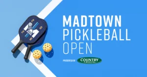 A pickleball paddle and two balls on a blue court with text: “Madtown Pickleball Open presented by Country Financial.”.